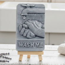 Load image into Gallery viewer, Gray soap with hands and faucet design on a stand, with 'Wash Me' text imprinted on soap