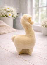 Load image into Gallery viewer, handmade vegan soap in the shape of a realistic standing alpaca or llama sculpture, featuring a smooth body with detailed fur texture on the head and neck, displayed in a bright farmhouse decor setting.