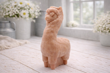Load image into Gallery viewer, handmade vegan soap in the shape of a realistic standing alpaca or llama sculpture, featuring a smooth body with detailed fur texture on the head and neck, displayed in a bright farmhouse decor setting.