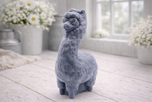 Load image into Gallery viewer, handmade vegan soap in the shape of a realistic standing alpaca or llama sculpture, featuring a smooth body with detailed fur texture on the head and neck, displayed in a bright farmhouse decor setting.