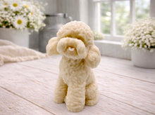 Load image into Gallery viewer, handmade vegan soap in the shape of a realistic sitting cockapoo or poodle sculpture, featuring detailed curly fur texture and a classic poodle groom, displayed on a rustic white wooden surface in a bright farmhouse decor setting.