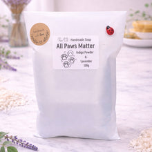 Load image into Gallery viewer, handmade vegan soap featuring a detailed 3D relief of various dog breeds sitting in a row with the text "all paws matter," displayed on a wooden easel against a rustic farmhouse decor background.