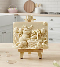 Load image into Gallery viewer, Intricate handmade soap scene from Soap Simple Creations featuring an Easter bunny, chicks, and tulips, displayed on a wooden easel with spring flowers. Vegan and cruelty free soap.