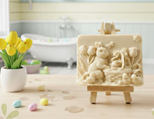 Load image into Gallery viewer, Intricate handmade soap scene from Soap Simple Creations featuring an Easter bunny, chicks, and tulips, displayed on a wooden easel with spring flowers. Vegan and cruelty free soap.