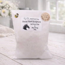 Load image into Gallery viewer, White soap bag with a label on a wooden surface, featuring a horse head sculpture design.