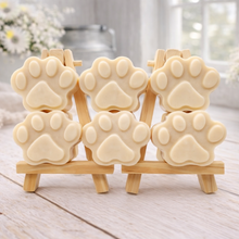 Load image into Gallery viewer, Set of dog paw-shaped vegan soaps on a wooden stand with a light background