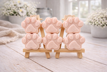 Load image into Gallery viewer, Pink paw-shaped vegan soap gift set on wooden stands with a blurred indoor background