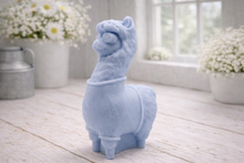 Load image into Gallery viewer, handmade vegan soap in the shape of a realistic standing alpaca or llama sculpture, featuring a smooth body with detailed fur texture on the head and neck, displayed in a bright farmhouse decor setting.