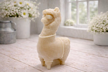 Load image into Gallery viewer, handmade vegan soap in the shape of a realistic standing alpaca or llama sculpture, featuring a smooth body with detailed fur texture on the head and neck, displayed in a bright farmhouse decor setting.
