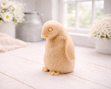 Load image into Gallery viewer, handmade vegan soap in the shape of a realistic young penguin sculpture, featuring a soft downy fur texture and a gentle expression, displayed in a bright farmhouse decor setting.