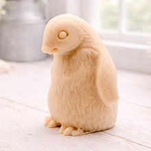 Load image into Gallery viewer, handmade vegan soap in the shape of a realistic young penguin sculpture, featuring a soft downy fur texture and a gentle expression, displayed in a bright farmhouse decor setting.