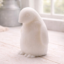 Load image into Gallery viewer, handmade vegan soap in the shape of a realistic young penguin sculpture, featuring a soft downy fur texture and a gentle expression, displayed in a bright farmhouse decor setting.