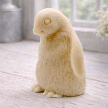 Load image into Gallery viewer, handmade vegan soap in the shape of a realistic young penguin sculpture, featuring a soft downy fur texture and a gentle expression, displayed in a bright farmhouse decor setting.
