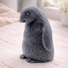 Load image into Gallery viewer, handmade vegan soap in the shape of a realistic young penguin sculpture, featuring a soft downy fur texture and a gentle expression, displayed in a bright farmhouse decor setting.