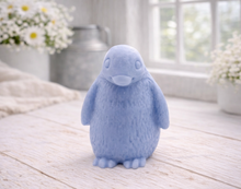 Load image into Gallery viewer, handmade vegan soap in the shape of a realistic young penguin sculpture, featuring a soft downy fur texture and a gentle expression, displayed in a bright farmhouse decor setting.