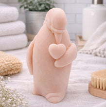 Load image into Gallery viewer, handmade vegan soap in the shape of a realistic penguin sculpture holding a small heart to its chest,