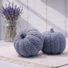 Load image into Gallery viewer, Two charcoal pumpkin vegan soaps / gift set on a light wooden floor with a vase of lavender in the background.