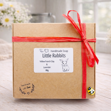 Load image into Gallery viewer, Handmade soap packaging with a red ribbon on a wooden surface