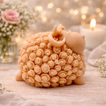 Load image into Gallery viewer, handmade vegan soap in the shape of a realistic smiling ram with curved horns and detailed curly wool texture, displayed on a rustic wooden surface with lavender and white flowers.