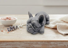 Load image into Gallery viewer, Handmade vegan soap in the shape of a realistic sleeping French Bulldog lying down, showing detailed ear texture and facial wrinkles, surrounded by bubbles in a marble bathroom setting.