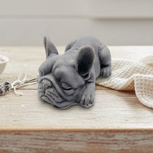 Load image into Gallery viewer, Handmade vegan soap in the shape of a realistic sleeping French Bulldog lying down, showing detailed ear texture and facial wrinkles, surrounded by bubbles in a marble bathroom setting.
