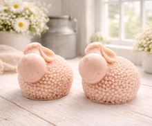 Load image into Gallery viewer, Two handmade vegan soap gift set featuring two fluffy spring lambs with detailed wool texture, displayed on a weathered white wooden surface in a bright farmhouse decor room