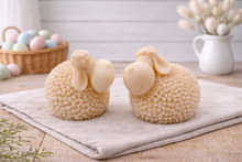 Load image into Gallery viewer, Two handmade vegan soaps in the shape of fluffy spring lambs with detailed wool texture, displayed on a weathered white wooden surface in a bright farmhouse decor room