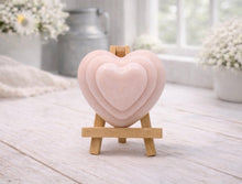 Load image into Gallery viewer, handmade vegan soap gift featuring a triple-tiered heart relief design, displayed on a wooden easel against a rustic farmhouse decor background with lavender.