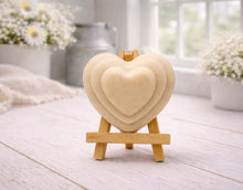 Load image into Gallery viewer, handmade vegan soap gift featuring a triple-tiered heart relief design, displayed on a wooden easel against a rustic farmhouse decor background with lavender.