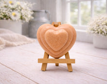 Load image into Gallery viewer, handmade vegan soap gift featuring a triple-tiered heart relief design, displayed on a wooden easel against a rustic farmhouse decor background with lavender.