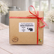 Load image into Gallery viewer, Handmade soap packaging with 'Baby Elephants' label on a wooden surface