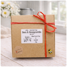 Load image into Gallery viewer, A handmade vegan soap gift set featuring six hexagonal bars stacked in a pyramid on a small wooden easel; some bars show a honeybee relief and others a honeycomb pattern