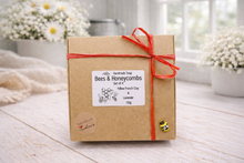 Load image into Gallery viewer, Kraft paper box with a red ribbon and 'Bees & Honeycombs' label on a wooden surface.