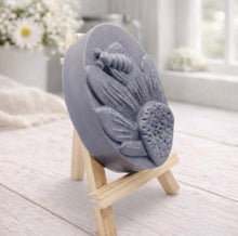 Load image into Gallery viewer, handmade vegan soap gift featuring a detailed honey bee landing on a large sunflower, displayed on a wooden easel against a whimsical farmhouse decor background.