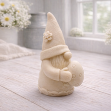 Load image into Gallery viewer, A detailed handmade vegan soap gift, sculpted as a whimsical Easter gnome (gonk) wearing a tall pointed hat with a flower detail, holding a large patterned Easter egg.