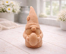 Load image into Gallery viewer, A detailed handmade vegan soap gift, sculpted as a whimsical Easter gnome (gonk) wearing a tall pointed hat with a flower detail, holding a large patterned Easter egg.