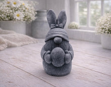 Load image into Gallery viewer, A detailed handmade vegan soap in a natural colour, sculpted as a whimsical Easter gnome (gonk) with long rabbit ears and a bow on its hat, holding a patterned Easter egg, displayed on a light wooden surface. Easter gift