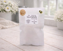 Load image into Gallery viewer, White soap packaging with a label on a wooden surface, flowers in the background