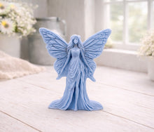Load image into Gallery viewer, A detailed handmade vegan soap featuring an elegant fairy with large, intricate butterfly-style wings, a flowing gown, and long hair, standing against a bright farmhouse window background.