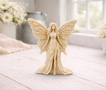Load image into Gallery viewer, A detailed handmade vegan soap featuring an elegant fairy with large, intricate butterfly-style wings, a flowing gown, and long hair, standing against a bright farmhouse window background.