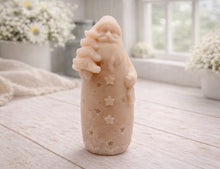 Load image into Gallery viewer, handmade vegan soap sculpted into a tall figure of Father Christmas wearing star-patterned robes, holding a small Christmas tree in one arm and a lantern in the other, set in a bright farmhouse window.
