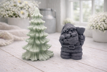 Load image into Gallery viewer, A duo of handmade vegan soaps featuring a Father Christmas figure with standing next to a mint-green tiered 3D Christmas tree, displayed in a bright farmhouse setting.