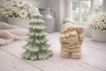 Load image into Gallery viewer, A duo of handmade vegan soaps featuring a Father Christmas figure with standing next to a mint-green tiered 3D Christmas tree, displayed in a bright farmhouse setting.