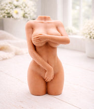 Load image into Gallery viewer, A 3D handmade vegan soap sculpted into a detailed female torso with soft, realistic curves and defined musculature and displayed in a bright farmhouse setting.