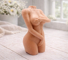 Load image into Gallery viewer, A handmade vegan soap sculpted into a detailed female torso with soft, realistic curves and defined musculature and displayed in a bright farmhouse setting.