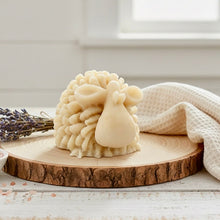 Load image into Gallery viewer, A highly detailed handmade vegan soap sculpted in the shape of a fluffy sheep with thick, textured wool and a smooth face, displayed on a light wooden surface in a farmhouse-style setting.