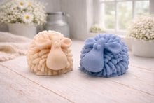 Load image into Gallery viewer, A highly detailed handmade vegan soap sculpted in the shape of a fluffy sheep with thick, textured wool and a smooth face, displayed on a light wooden surface in a farmhouse-style setting.