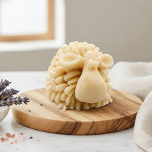 Load image into Gallery viewer, A highly detailed handmade vegan soap sculpted in the shape of a fluffy sheep with thick, textured wool and a smooth face, displayed on a light wooden surface in a farmhouse-style setting.