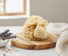 Load image into Gallery viewer, A highly detailed handmade vegan soap sculpted in the shape of a fluffy sheep with thick, textured wool and a smooth face, displayed on a light wooden surface in a farmhouse-style setting.