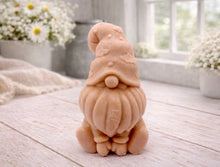 Load image into Gallery viewer, A handmade vegan soap in a natural tone, sculpted as a gnome (gonk) with a tall, curved hat that covers the eyes and has clouds on it, a round nose, and a long, textured beard.